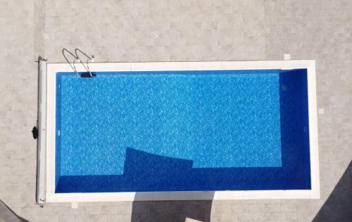 a blue swimming pool with stairs in a room at BLU OCEANO (Casa Vacanza) in Guardialfiera