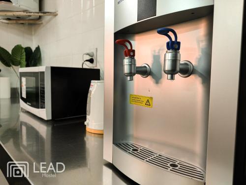 two pictures of a kitchen with a microwave at Lead Hostel in Buenos Aires