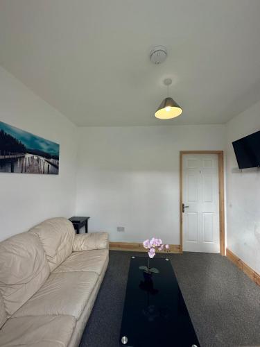 a living room with a couch and a table at Browning House Bedrooms I Long or Short Stay I Special Rate Available in Derby