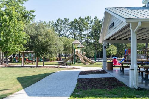 a park with a playground with a slide at Encanto of the Lowcountry in Old Town Bluffton in Bluffton