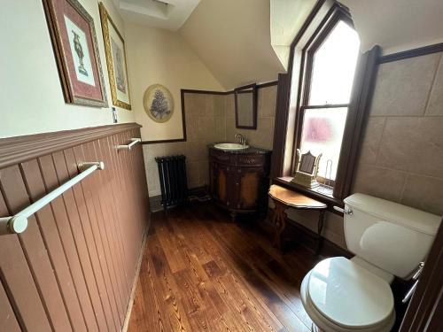 a bathroom with a toilet and a window and a sink at THE RED STAR ROOM D in Niagara Falls