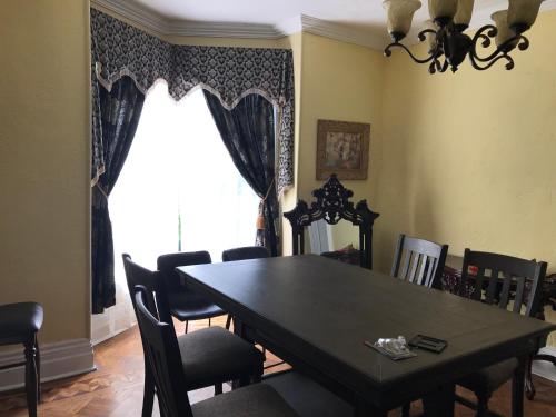 a dining room with a table and chairs and a window at THE RED STAR ROOM D in Niagara Falls