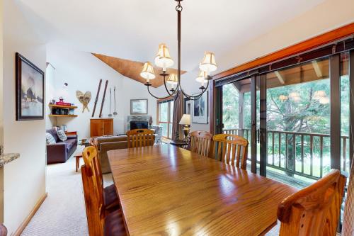a dining room with a wooden table and chairs at Trail Creek 62 in Killington