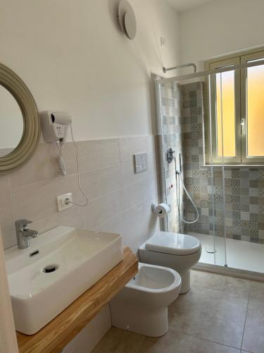 a bathroom with a sink and a toilet and a shower at Il Marchesino B&B in Pizzo