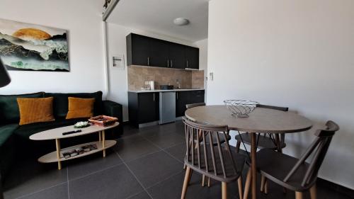 a living room with a couch and a table at Olympia Suites in Pýrgos