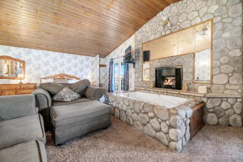 a large bathroom with a tub and a fireplace at Black Forest Lodge in Big Bear Lake
