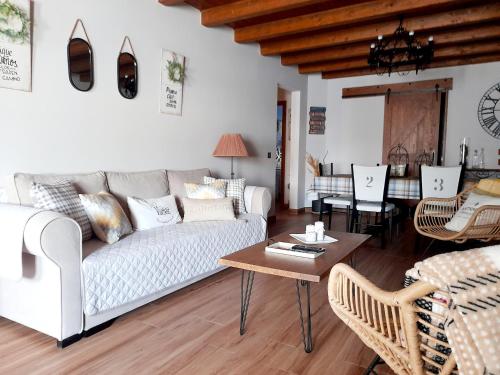 a living room with a couch and a table at CASA RURAL EL TRASTERO DE CARMELO in Maello