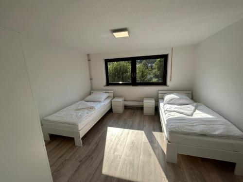 two beds in a room with a window at Ferienhaus in Amstetten 