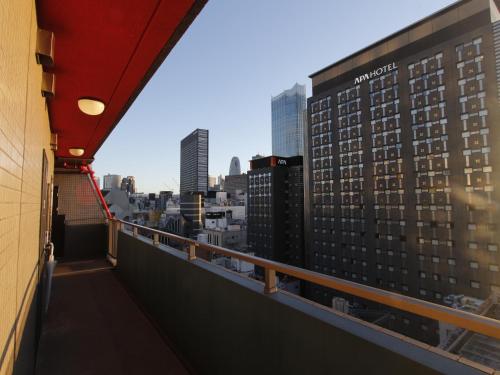 a view of the city from the balcony of a building at Duo Scala Shinjuku 東新宿 in Tokyo