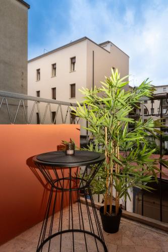 a black table on a balcony with plants at Camelia Rooms Venice Guesthouse in Mestre