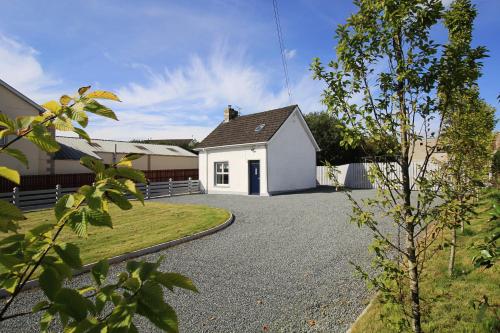 ein weißes Haus mit Auffahrt in der Unterkunft The Wee House in Muff