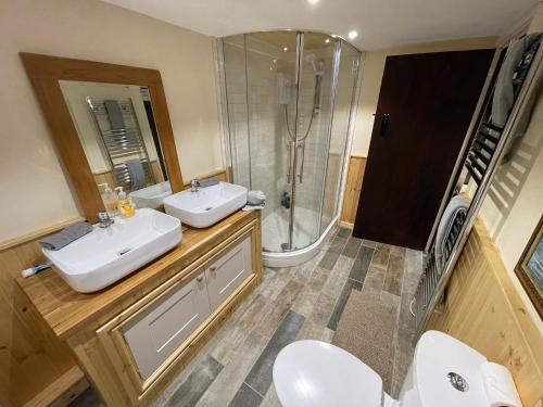 a bathroom with a sink and a shower and toilet at Large Historic Farmhouse in Rhondda Valley Perfect for Groups with Hot Tub in Blaencwm
