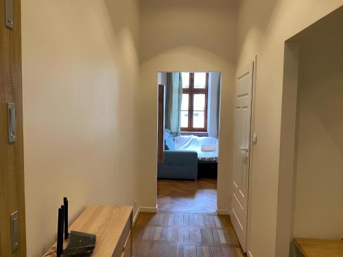 a hallway with a room with a bed and a window at Cozy Flat in Rynek in Wrocław