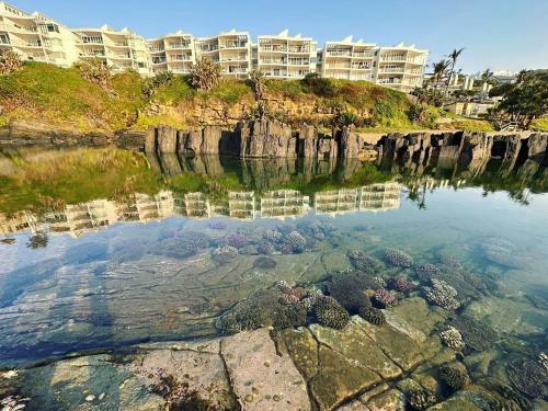 a large body of water with buildings in the background at Chakas Cove in Ballito