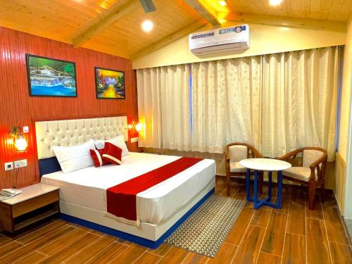 a hotel room with a bed and a table and a room at Hotel Wood Stock Luxury - A Boutique Property - Penthouse - Open Air Restaurant & Terrace in Kasauli