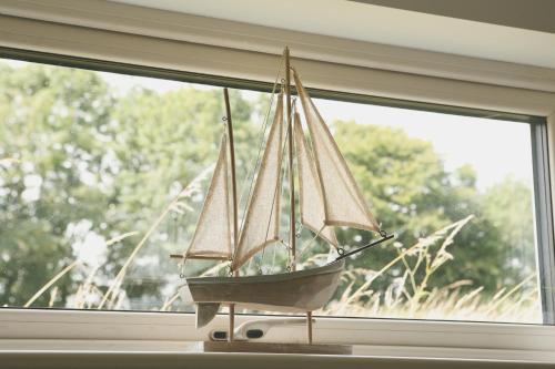a model boat sitting on a window sill at Ocean Breeze in Cork