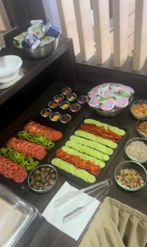 a table with many different types of food in bowls at Apart Lux Beciragic in Dobra Voda