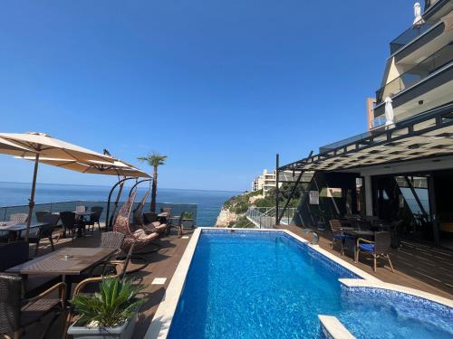 a swimming pool with a view of the ocean at Apart Lux Beciragic in Dobra Voda
