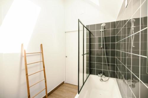 a bathroom with a shower with a glass door at Loft du Pain avec SPA privatif in Druye