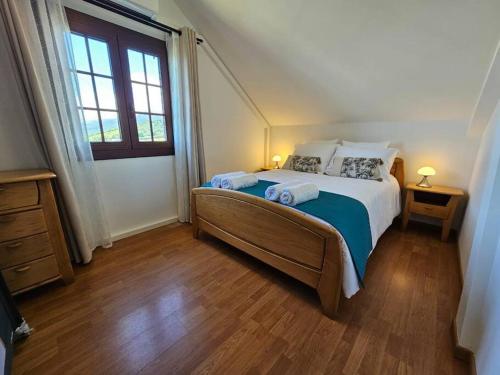 a bedroom with a large bed and a window at Ilodays in La Plaine des Cafres