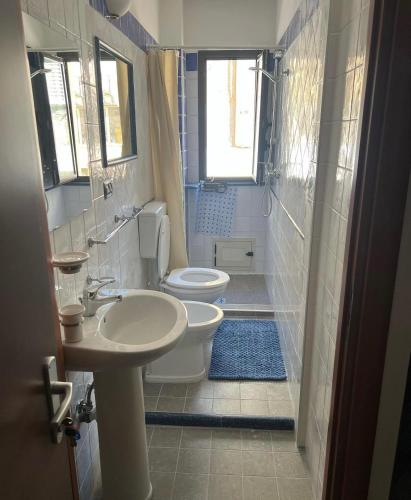 a bathroom with two toilets and a sink at La matrice in Palmi