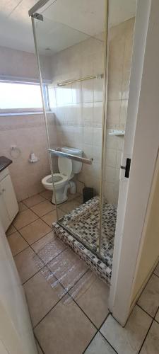 a bathroom with a toilet and a glass shower at Santana holiday resort 803 in Margate