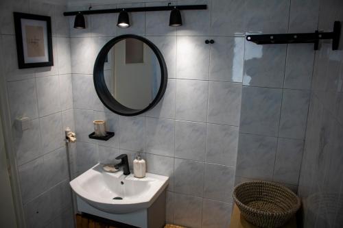 a bathroom with a sink and a mirror at Acropolis rooftop view, 200m from Neos kosmos metro station in Athens