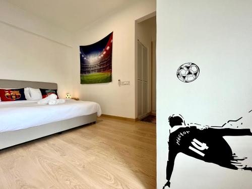 a bedroom with a bed and a soccer ball on the wall at Netflix-Seaview-SunsetView-PuteriBeach-Mutiara Beach Resort Melaka in Kampong Pantai Dusun
