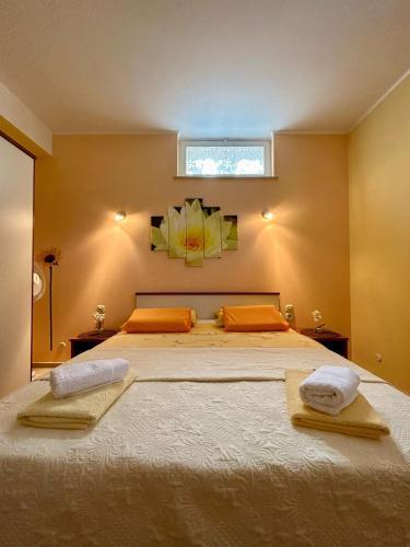 a bedroom with a large bed with two towels on it at Apartments Korta in Račišće