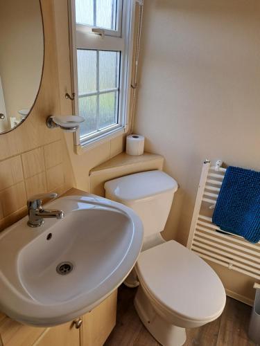 a bathroom with a sink and a toilet and a mirror at Seaview in Skegness