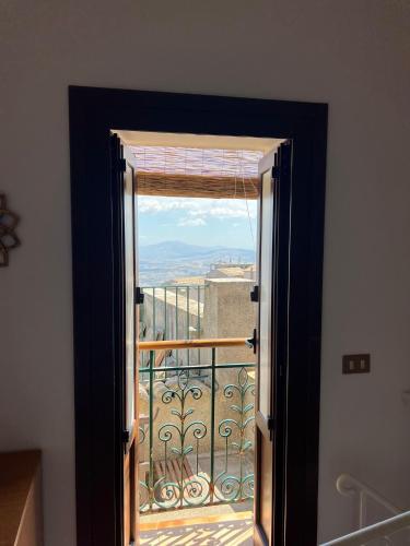 an open door to a balcony with a view at La Chiocciola - Casa vacanze in Erice