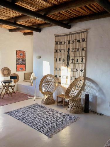 a living room with two chairs and a rug at AGAVE HOUSE in Prince Albert