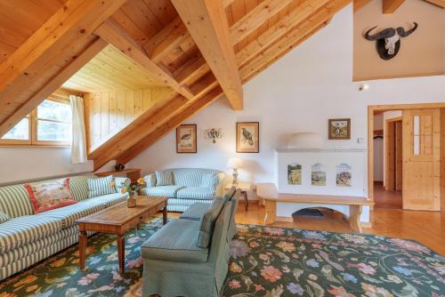 a living room with two couches and a table at Chalet Windegg in Sankt Anton am Arlberg