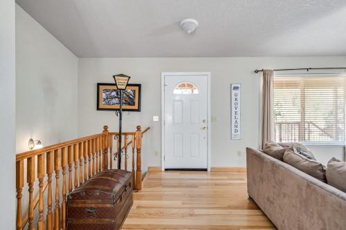 a living room with a couch and a staircase at Fisherman's Cove Retreat - Game Room Included! home in Groveland