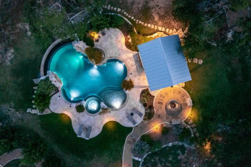 an overhead view of a pool in a park at night at Driftwood Casitas - Birdsong Casita in Wimberley