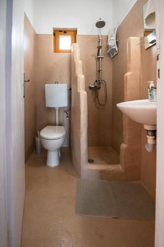a bathroom with a toilet and a sink at George Seaside Serviced Studios & Apartments in Pefki