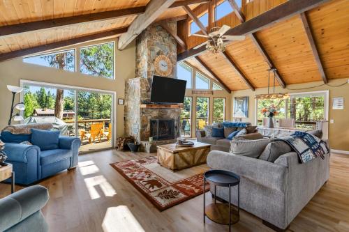 a living room with couches and a fireplace at Water's Edge - Gorgeous Water Views! home in Groveland