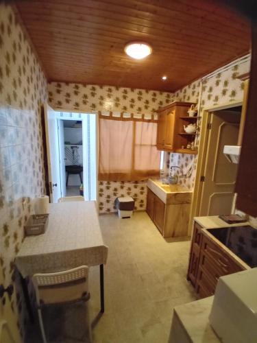 a kitchen with a table and a counter top at T3 1 andar Avenida Ref 003 in Tavira