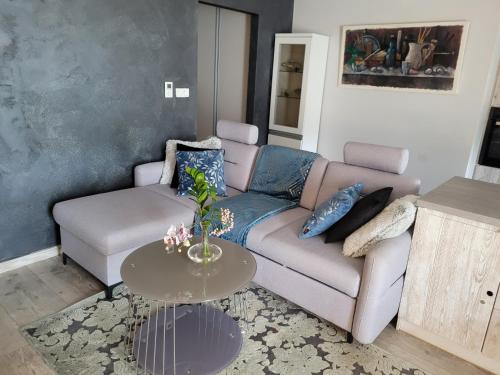 a living room with a couch and a table at Apartament LILLA in Jelenia Góra