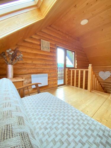 a bedroom with a bed in a log cabin at Садиба Краєвських in Krapivnik