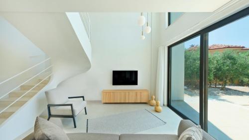 uma sala de estar com um sofá e uma televisão em Villa Neo with Jakuzi,indoor pool,sauna and floor heating em Fethiye