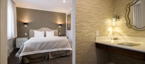 a bedroom with a bed and a bathroom with a sink at Woodcrest Hotel Cupertino in Santa Clara