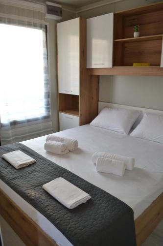 a bedroom with a large bed with towels on it at Oneiropagida House in Sarti