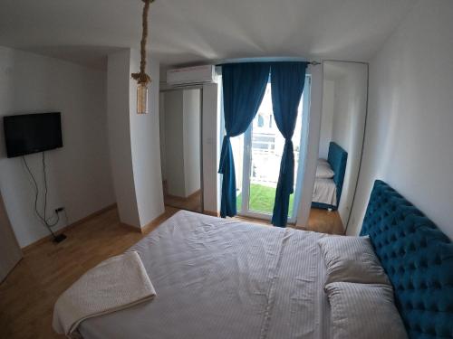 1 dormitorio con cama y ventana grande en Bella Lux Centar, en Mladenovac