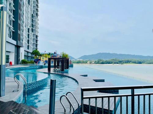 a swimming pool with a view of a body of water at Kuantan Imperium Residence Studio With Netflix by I-Home in Kuantan