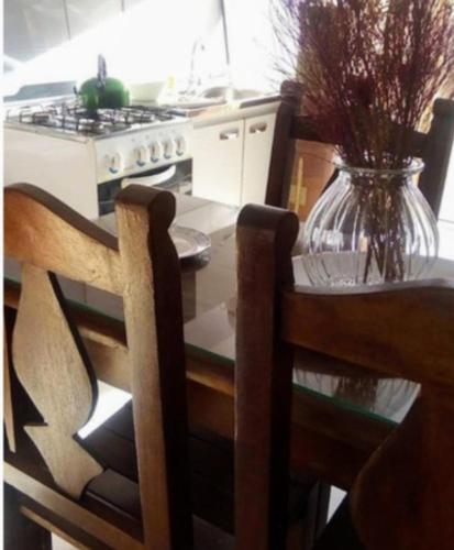 a kitchen with a table with a vase on it at Amor amor in San Luis