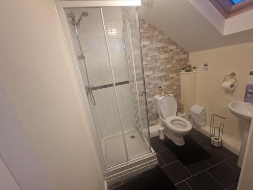 a bathroom with a shower and a toilet and a sink at Getaway Haven 