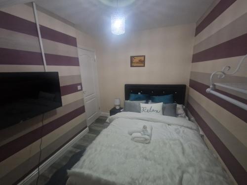 a small bedroom with a bed and a tv at Getaway Haven 
