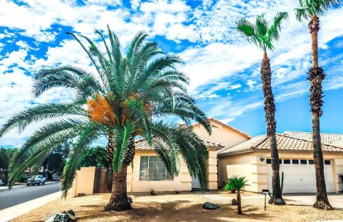 two palm trees in front of a house at North Phoenix At Your Fingertips in Phoenix
