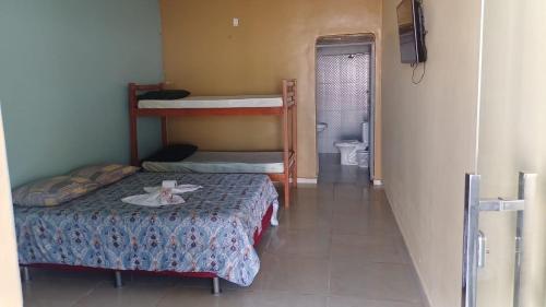 a small room with two bunk beds and a hallway at Hotel Gods Time Is The Best in Boa Vista